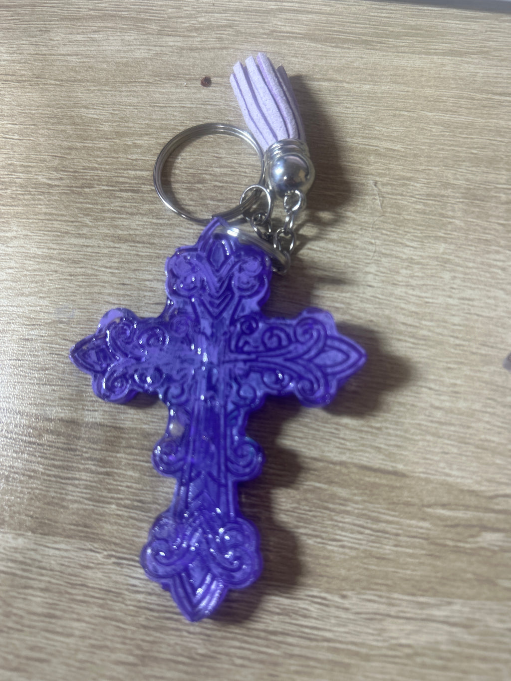 Purple resin ornate cross keychain with white tassel and silver ring