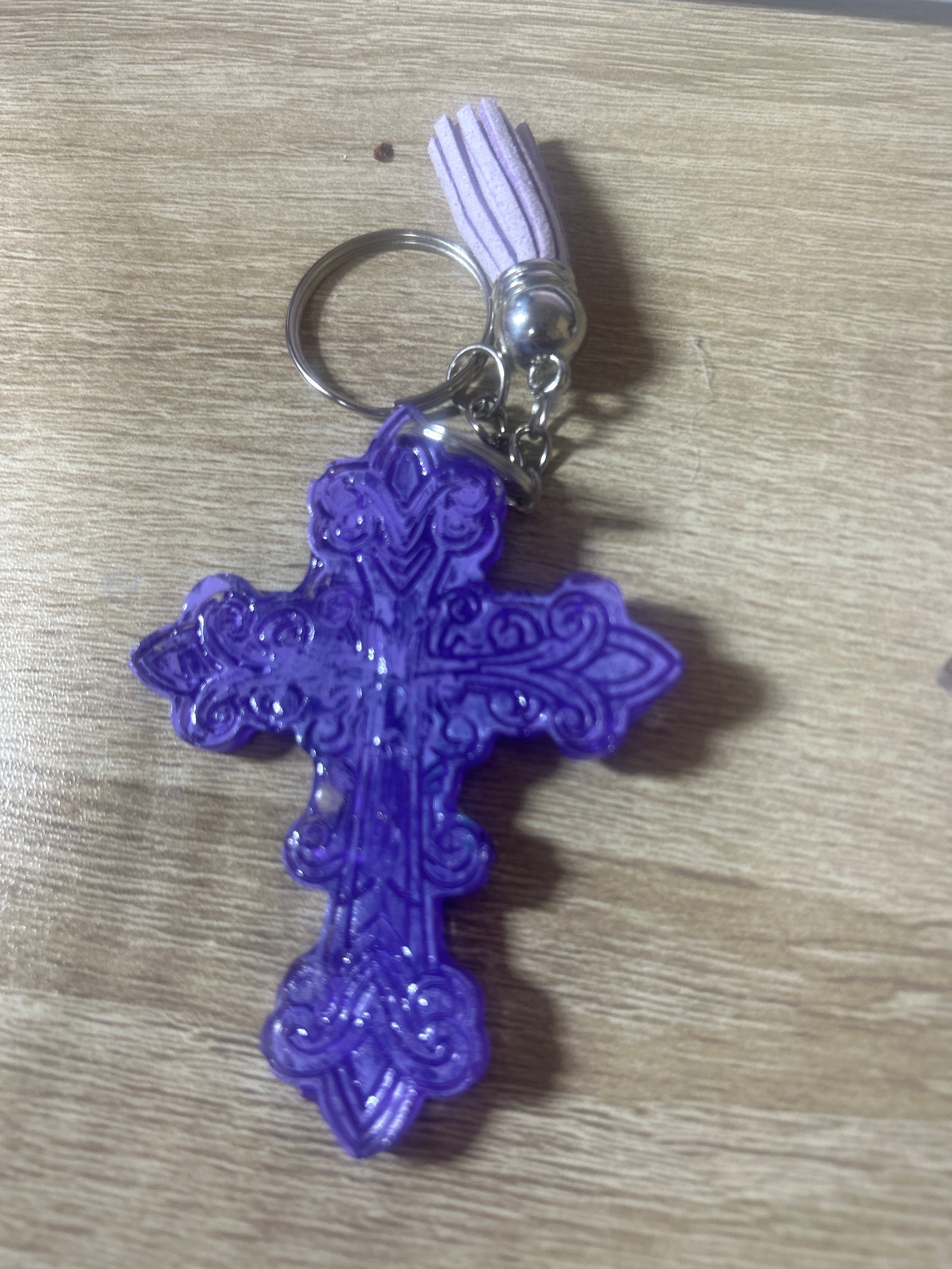 Purple resin ornate cross keychain with white tassel and silver ring