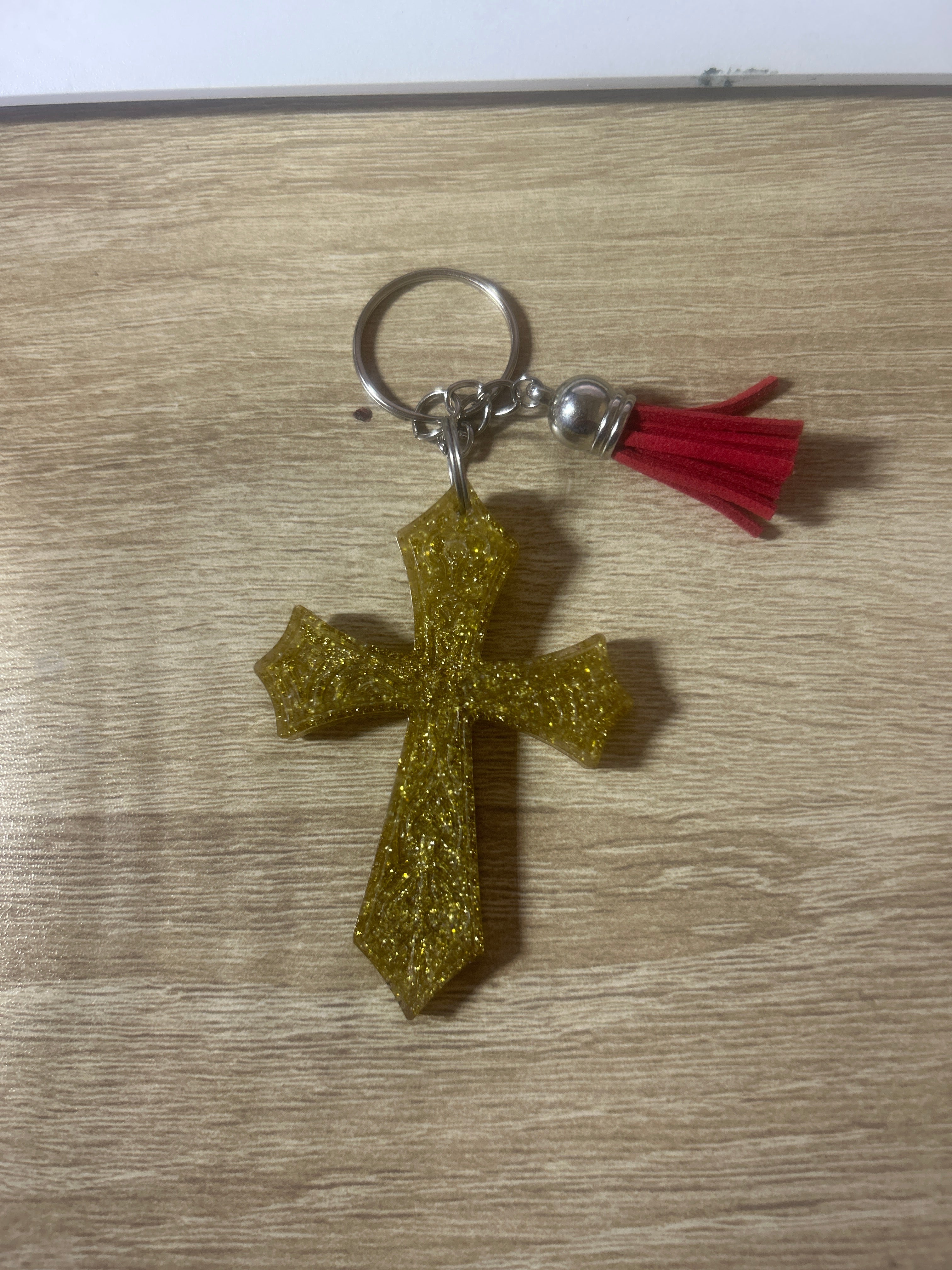 Gold glitter resin cross keychain with red tassel and silver ring