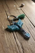 Teal butterfly wing cross keychain lifestyle photo