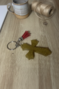 Gold glitter resin cross keychain lifestyle photo